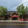 The Silver Creek restaurant, a wooden lodge building with a red canoe over the entrance and red chairs on the porch, is a popular stop for Sun Valley fly fishing.