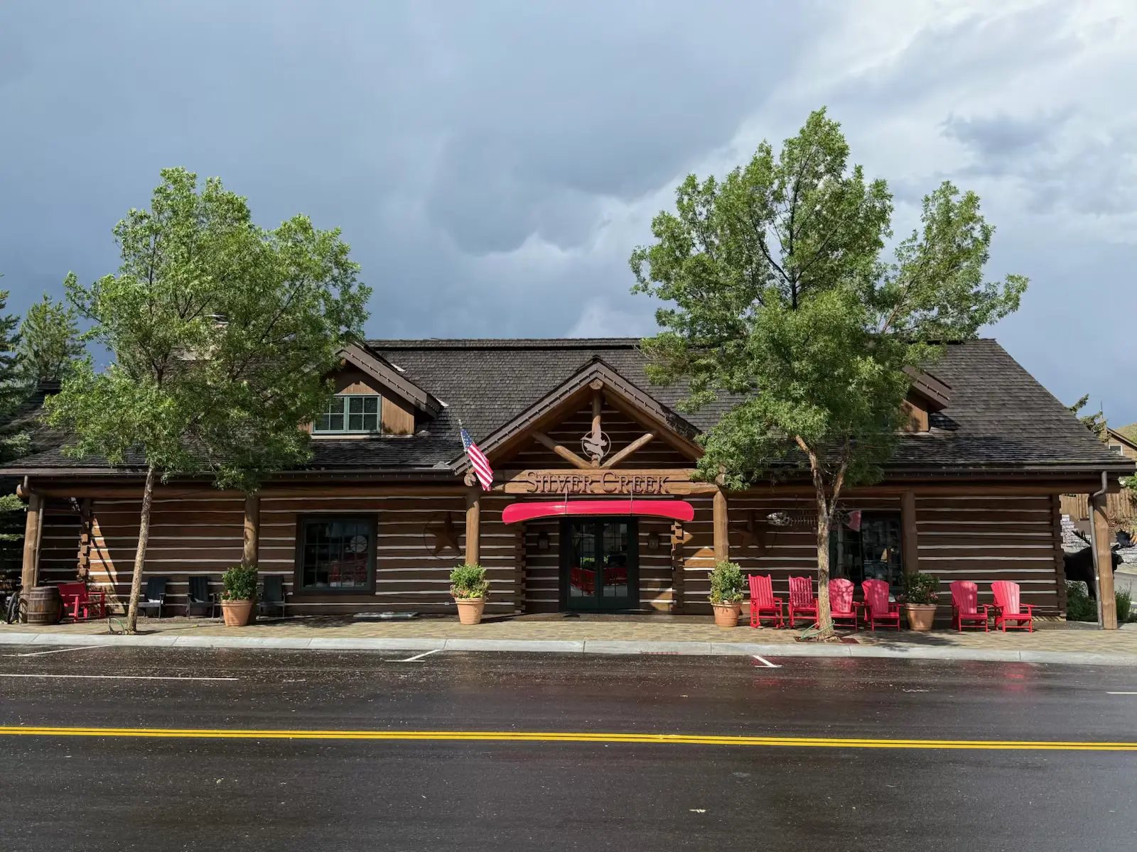 The Silver Creek restaurant, a wooden lodge building with a red canoe over the entrance and red chairs on the porch, is a popular stop for Sun Valley fly fishing.